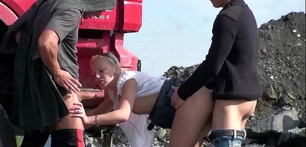  Construction site public gangbang threesome sex orgy with a cute blonde teen girl with nice perky tits and 2 hung guys with big dicks shoving their cocks in her mouth deep throat blowjob action and vaginal intercourse facking her young tight wet pussy